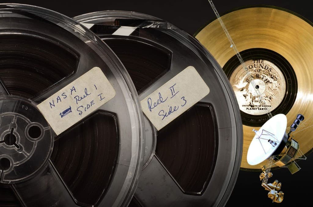 NASA tape reels beside the Voyager Golden Record and spacecraft